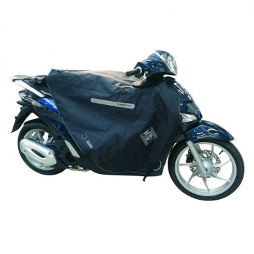 TABLIER COUVRE JAMBE TUCANO POUR PIAGGIO 50-125 LIBERTY 2016> (R184-x) (TERMOSCUD) (SYSTEME ANTI-FLOTTEMENT SGAS)